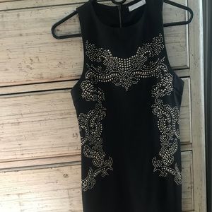 Black body con dress with gold detailing.